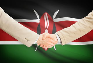 Businessmen shaking hands with flag on background